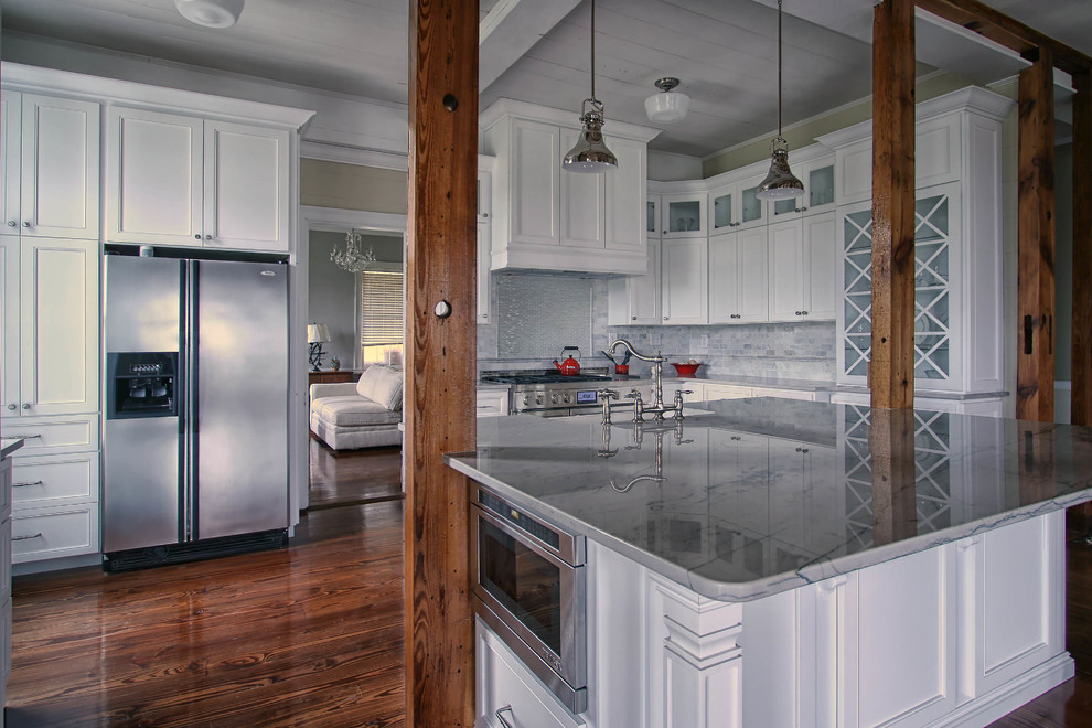 Inspiration for a transitional kitchen in Charlotte with a farmhouse sink, flat-panel cabinets, white cabinets, quartzite benchtops, grey splashback, glass tile splashback, stainless steel appliances, dark hardwood floors and with island.