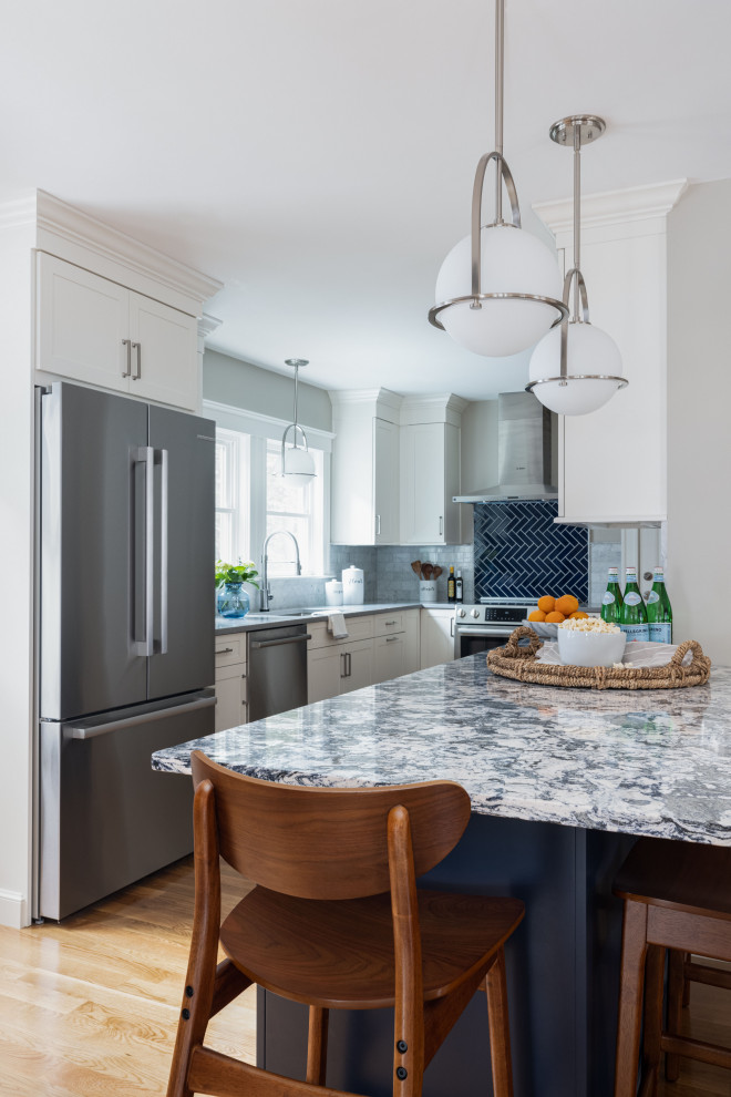 Traditional open plan kitchen in Boston with a submerged sink, shaker cabinets, blue cabinets, engineered stone countertops, multi-coloured splashback, marble splashback, stainless steel appliances, light hardwood flooring, a breakfast bar and multicoloured worktops.