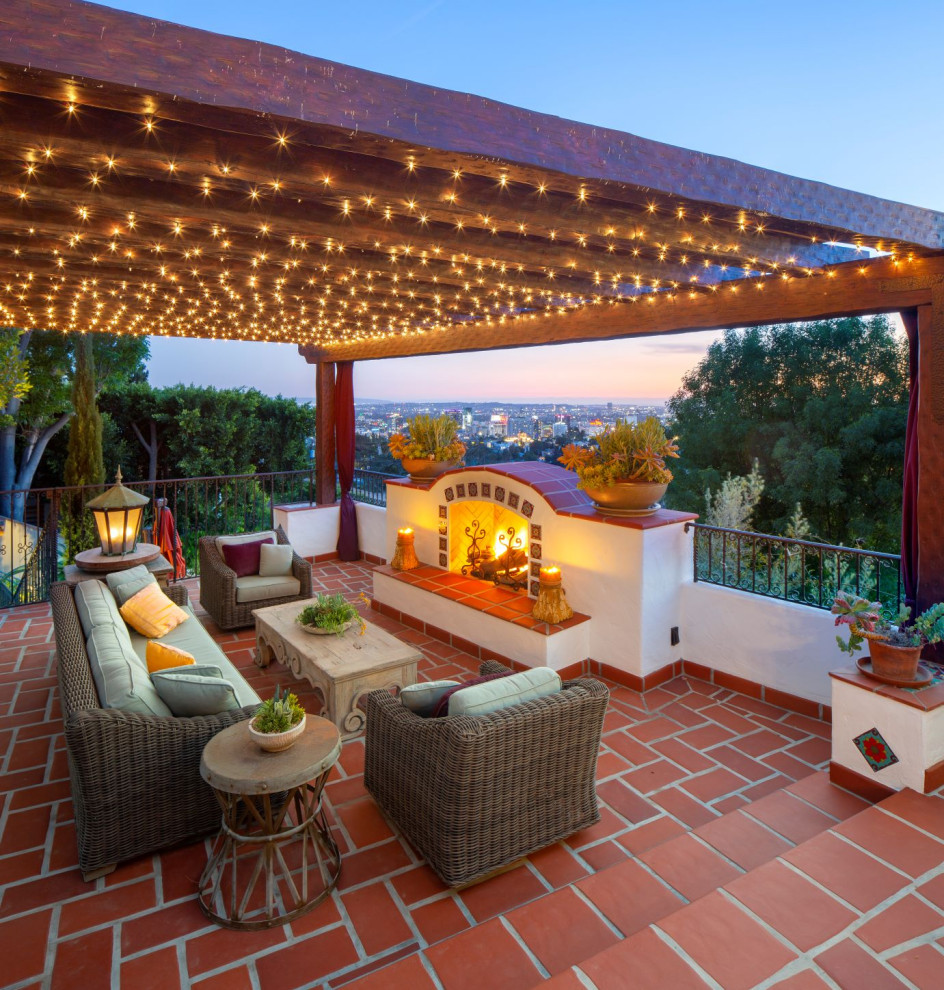 Diseño de terraza mediterránea con pérgola, barandilla de metal y iluminación