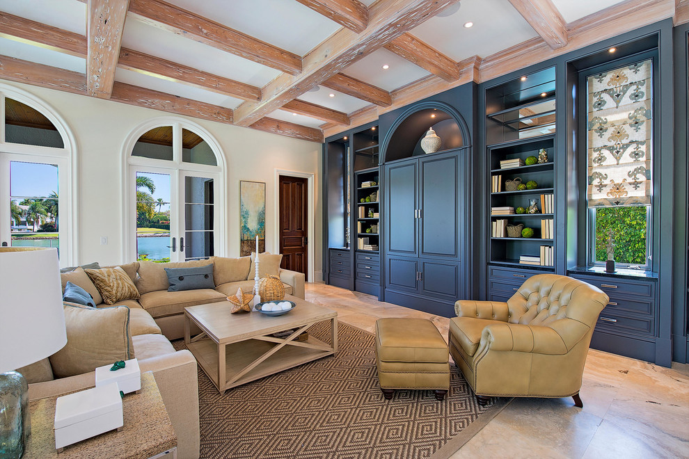 Inspiration for a mediterranean living room remodel in Miami with beige walls and a concealed tv