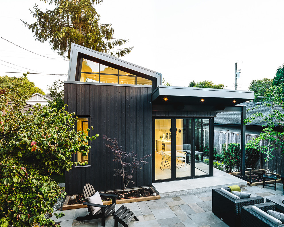 Design ideas for a mid-sized scandinavian one-storey black house exterior in Vancouver with wood siding.