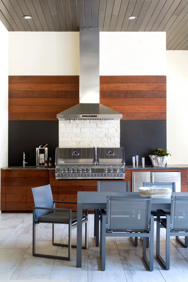 Example of a trendy tile patio design in Little Rock with a roof extension and a bbq area