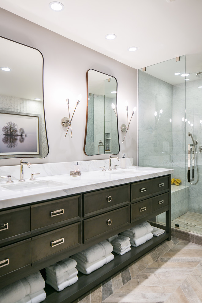 Inspiration for a mid-sized transitional master bathroom in Denver with brown cabinets, a freestanding tub, a corner shower, a two-piece toilet, gray tile, marble, grey walls, porcelain floors, an undermount sink, quartzite benchtops, grey floor, a hinged shower door and recessed-panel cabinets.