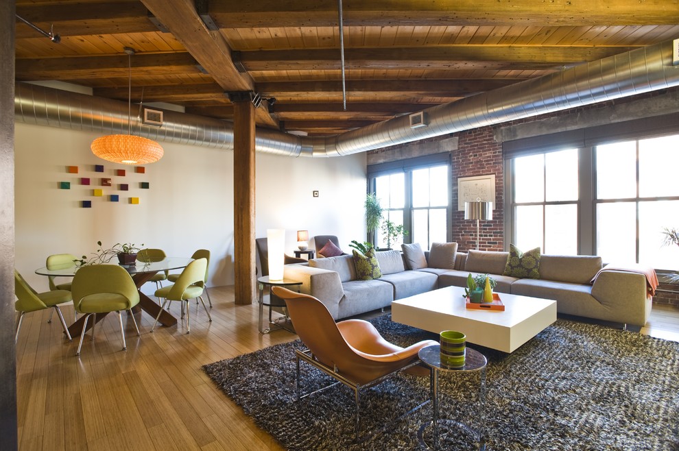 Inspiration for an industrial family room in Boston with light hardwood floors.
