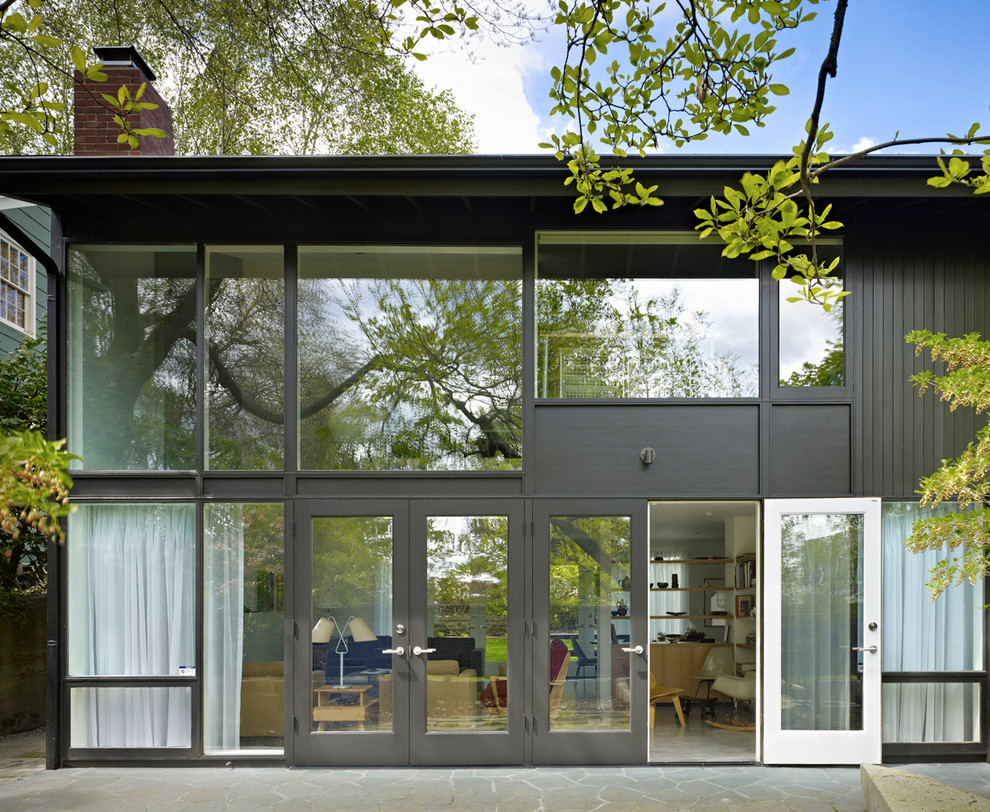 This is an example of a midcentury two-storey grey exterior in Seattle.
