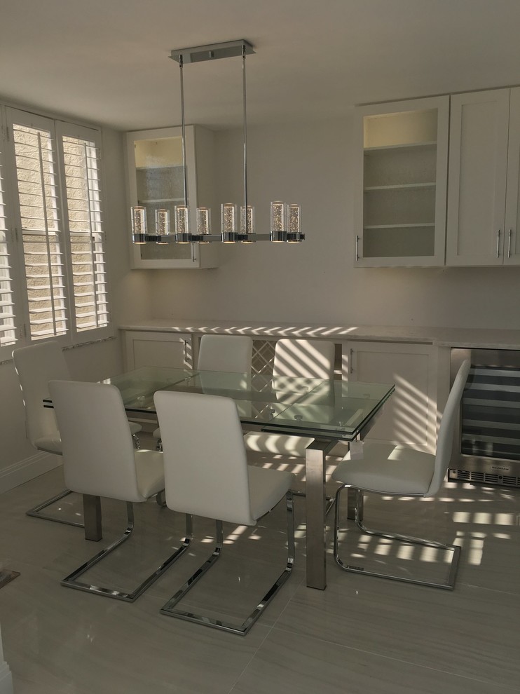 Inspiration for a small modern open plan dining in Miami with white walls and porcelain floors.