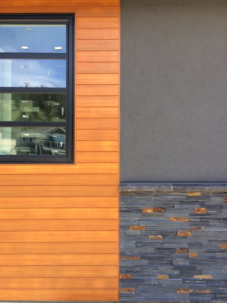 Modern grey exterior in Vancouver with stone veneer.