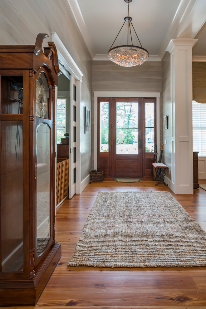 Entry hall - large transitional medium tone wood floor entry hall idea in Charleston with gray walls and a medium wood front door