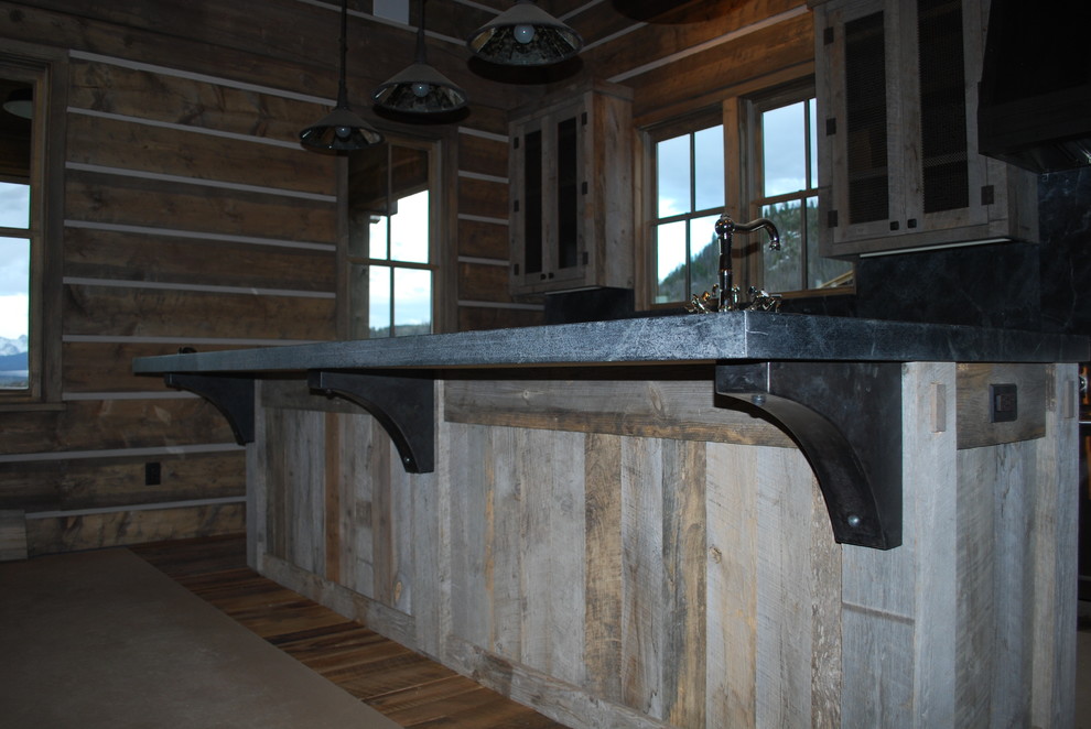 Mid-sized country kitchen in Denver with shaker cabinets, light wood cabinets, soapstone benchtops and with island.