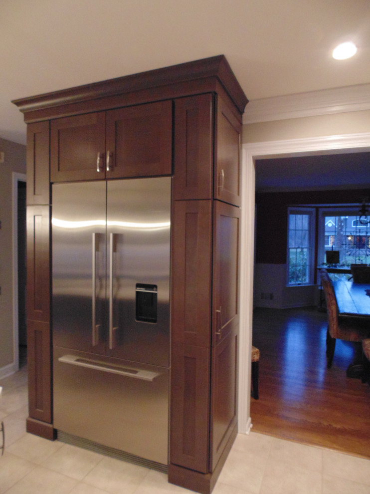Inspiration for a mid-sized transitional u-shaped ceramic tile and beige floor eat-in kitchen remodel with an undermount sink, recessed-panel cabinets, dark wood cabinets, quartz countertops, white backsplash, stone slab backsplash, stainless steel appliances, an island and white countertops