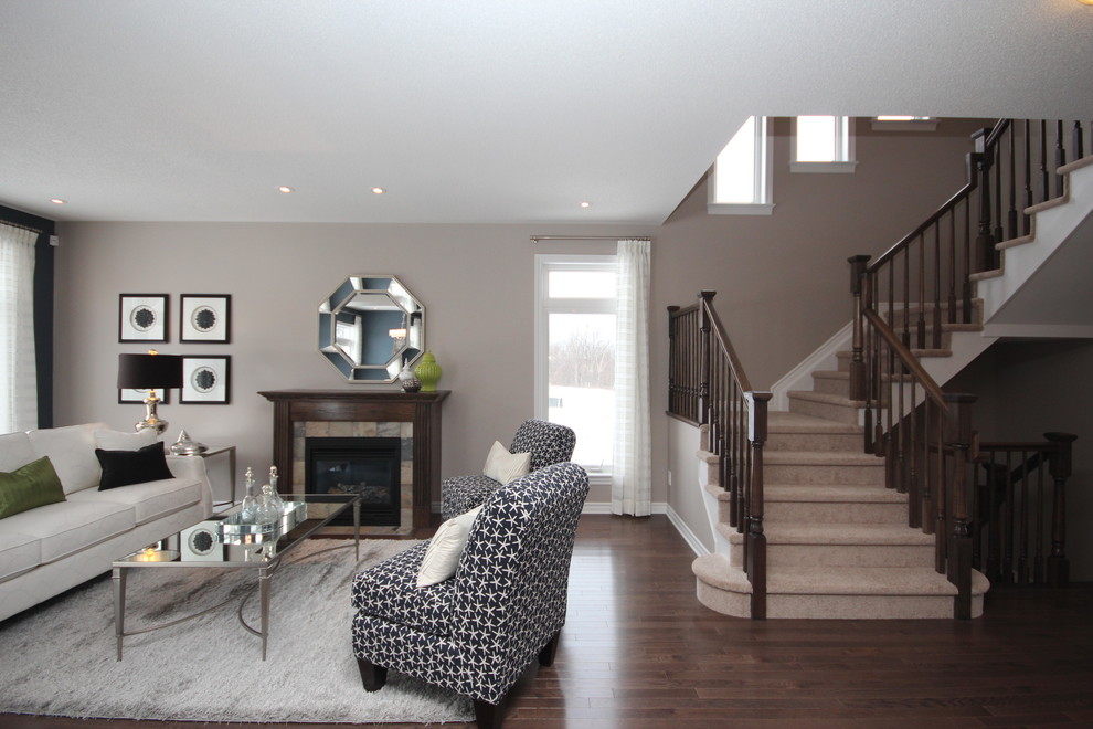 Mid-sized transitional formal open concept living room in Ottawa with beige walls, dark hardwood floors, a standard fireplace, a tile fireplace surround, no tv and brown floor.