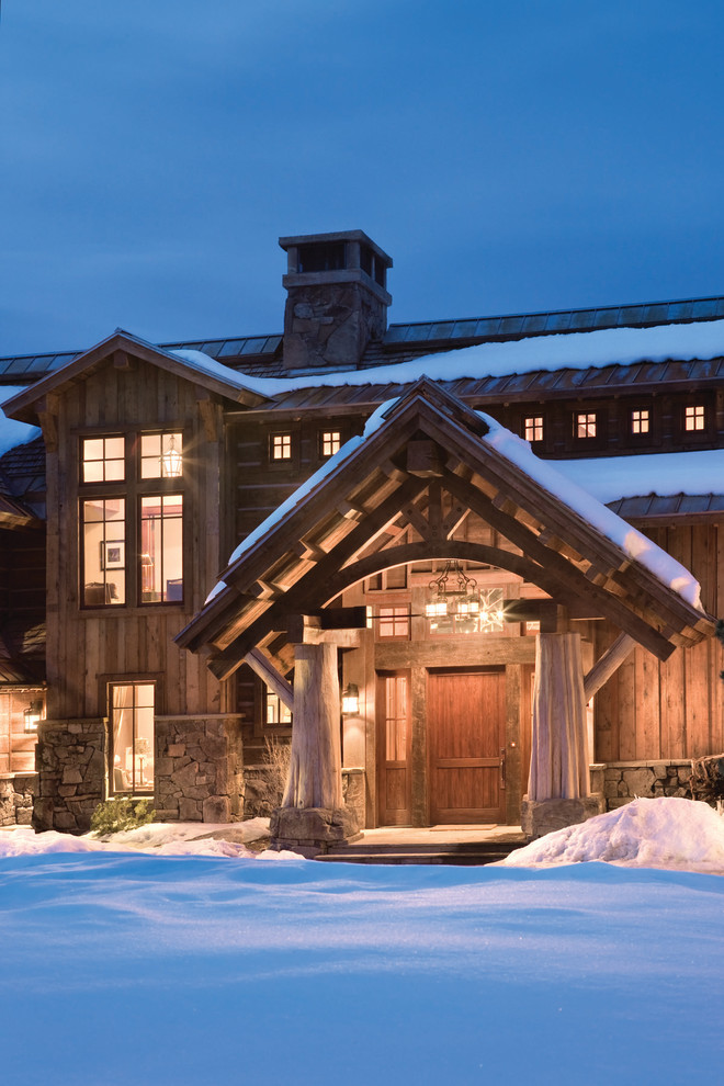 This is an example of a large country entryway in Other with a single front door and a dark wood front door.