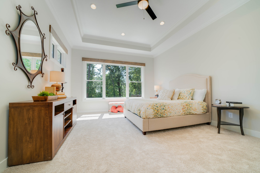 Large eclectic master bedroom in Grand Rapids with white walls, light hardwood floors, a standard fireplace, brown floor and exposed beam.
