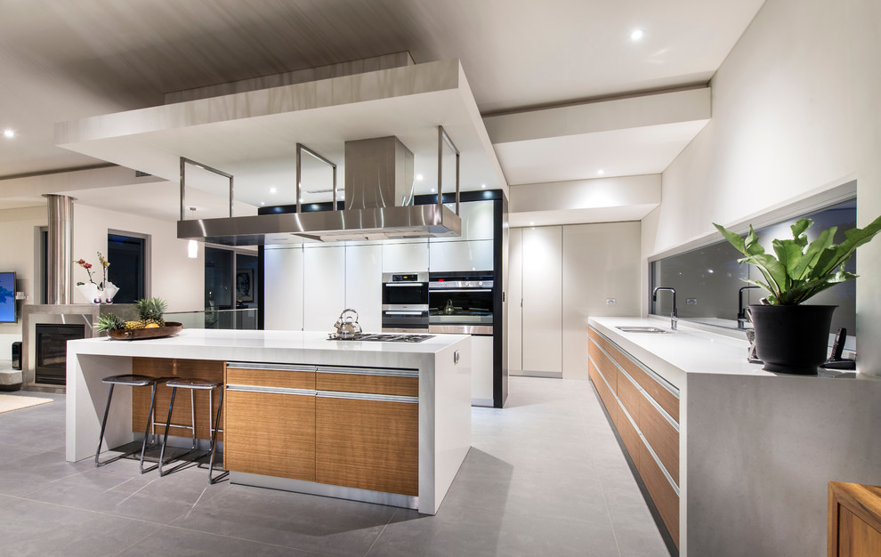Inspiration for a contemporary l-shaped kitchen in Perth with flat-panel cabinets, medium wood cabinets, stainless steel appliances and with island.