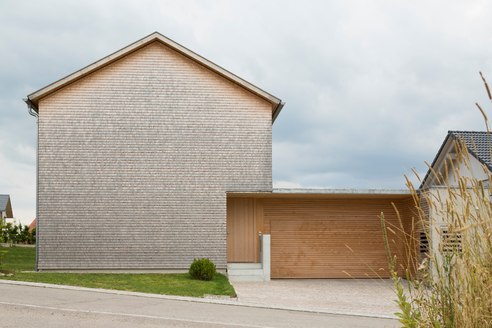 Large contemporary brick brown exterior in Other with a gable roof.