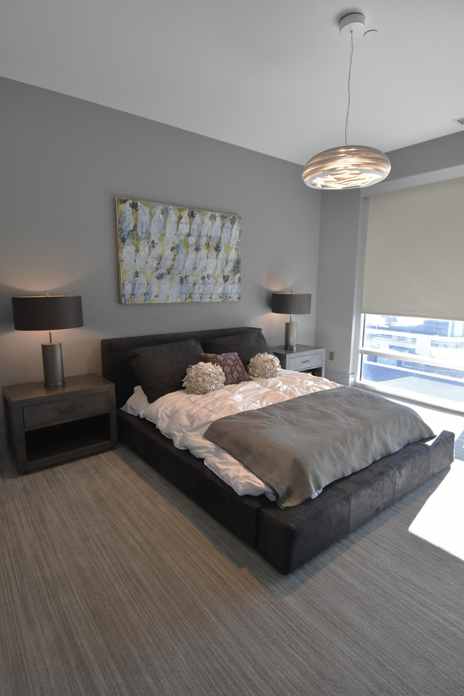 Photo of a mid-sized modern master bedroom in Charlotte with grey walls, carpet and grey floor.