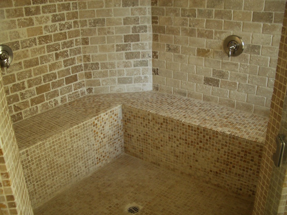 Small mediterranean 3/4 bathroom in Los Angeles with raised-panel cabinets, dark wood cabinets, a drop-in tub, an alcove shower, a one-piece toilet, multi-coloured tile, stone tile, beige walls, travertine floors, a drop-in sink, concrete benchtops, multi-coloured floor, a hinged shower door and beige benchtops.