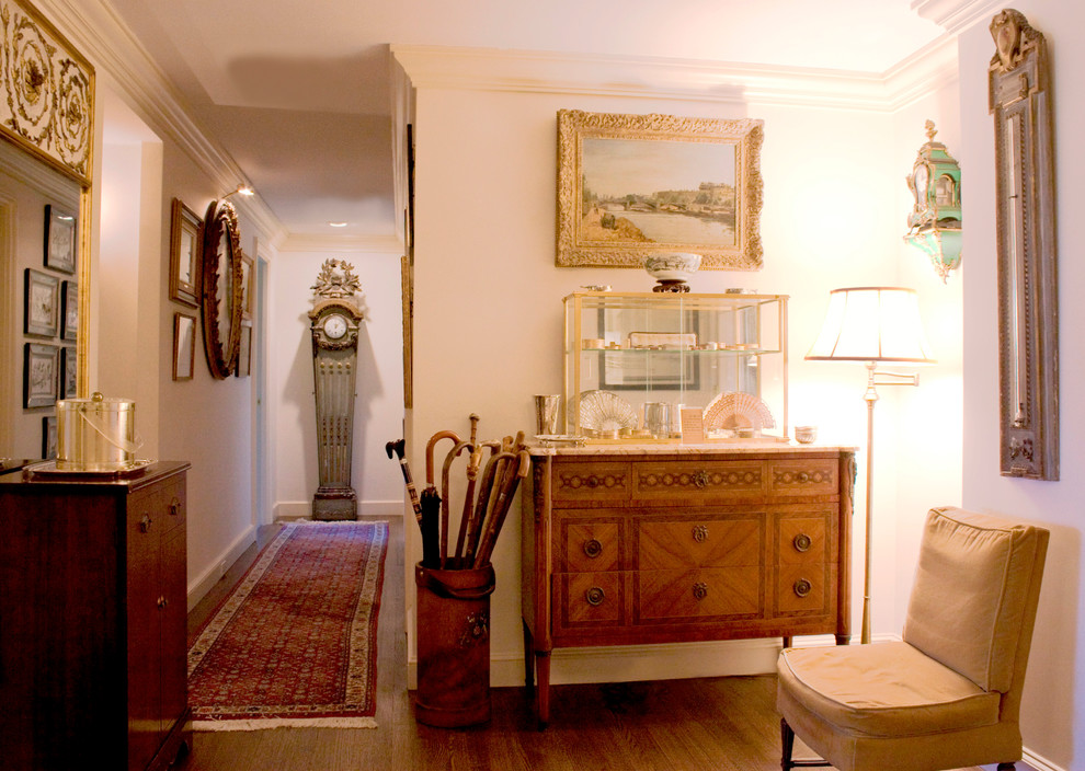 Inspiration for a traditional hallway in Boston with white walls and dark hardwood floors.