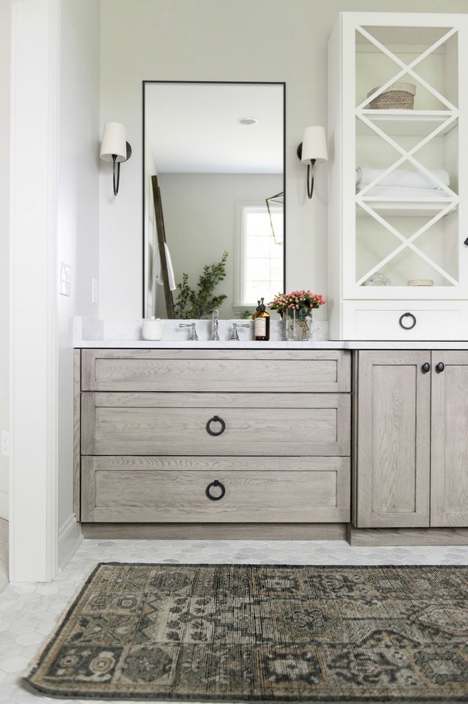 Inspiration for a large transitional master white tile and subway tile marble floor and white floor freestanding bathtub remodel in Indianapolis with shaker cabinets, medium tone wood cabinets, a one-piece toilet, white walls, an undermount sink, marble countertops and a hinged shower door