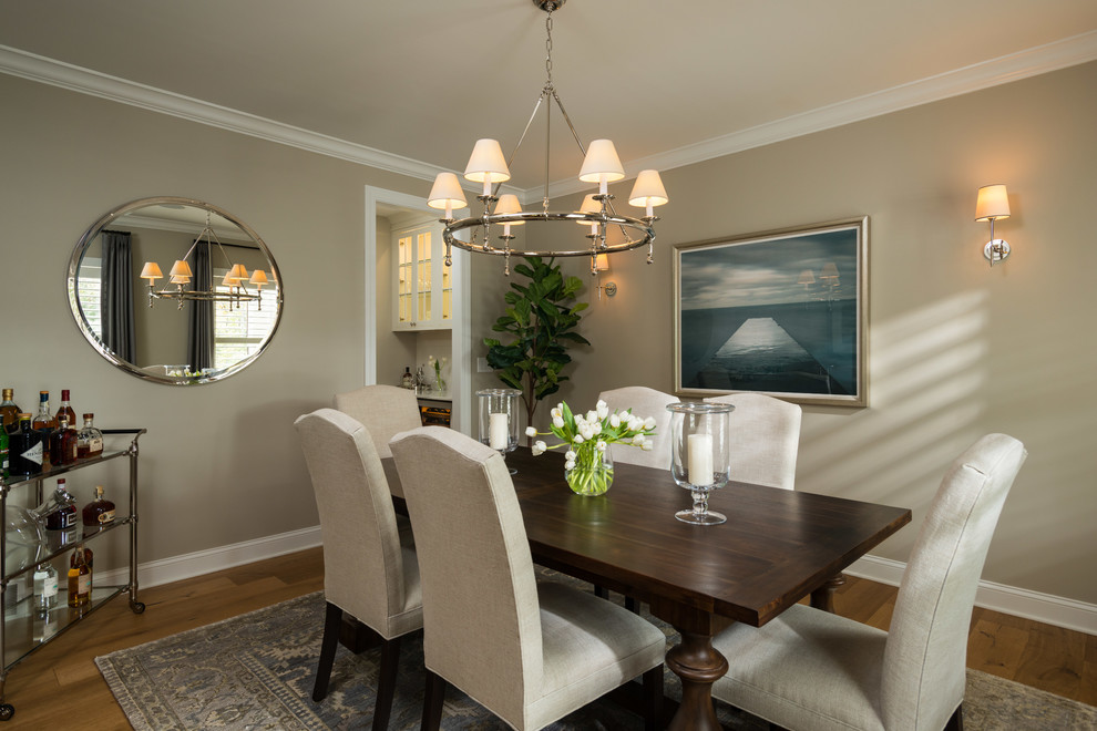 Photo of a transitional separate dining room in Boston with beige walls, medium hardwood floors and brown floor.