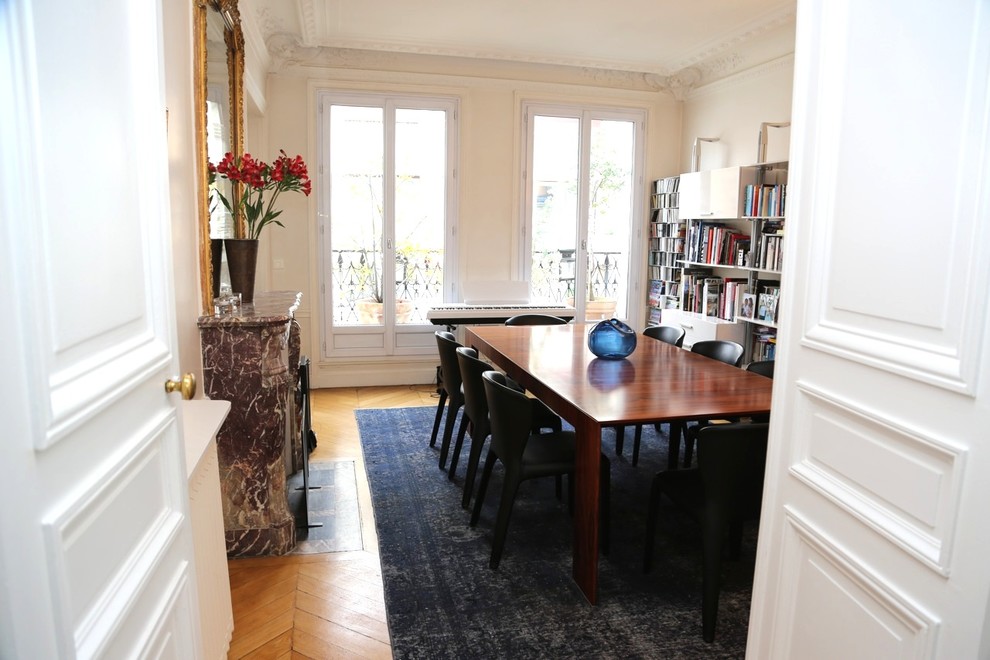 Large contemporary separate dining room in Paris with beige walls and plywood floors.