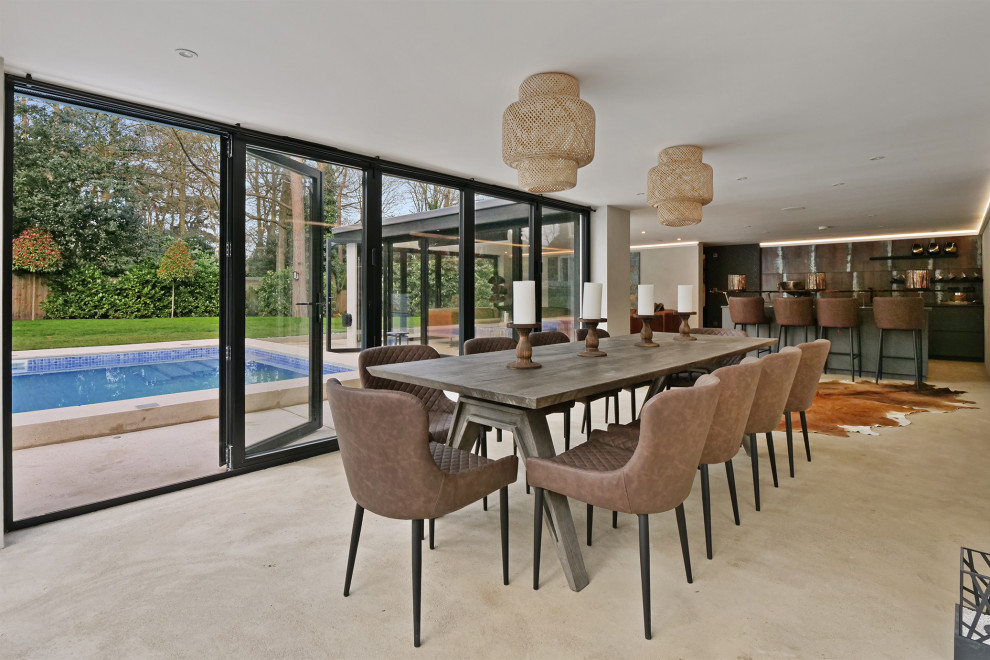 This is an example of a contemporary open plan dining room in Other with grey walls, concrete flooring and grey floors.