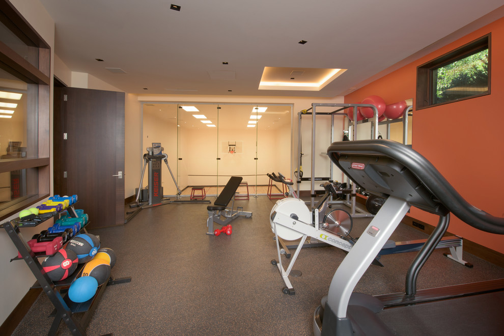 Inspiration for a large contemporary multipurpose gym in Denver with orange walls.