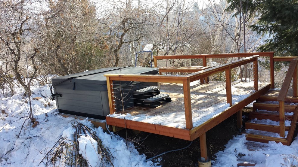 Photo of a mid-sized traditional backyard aboveground pool in Salt Lake City with a hot tub and decking.