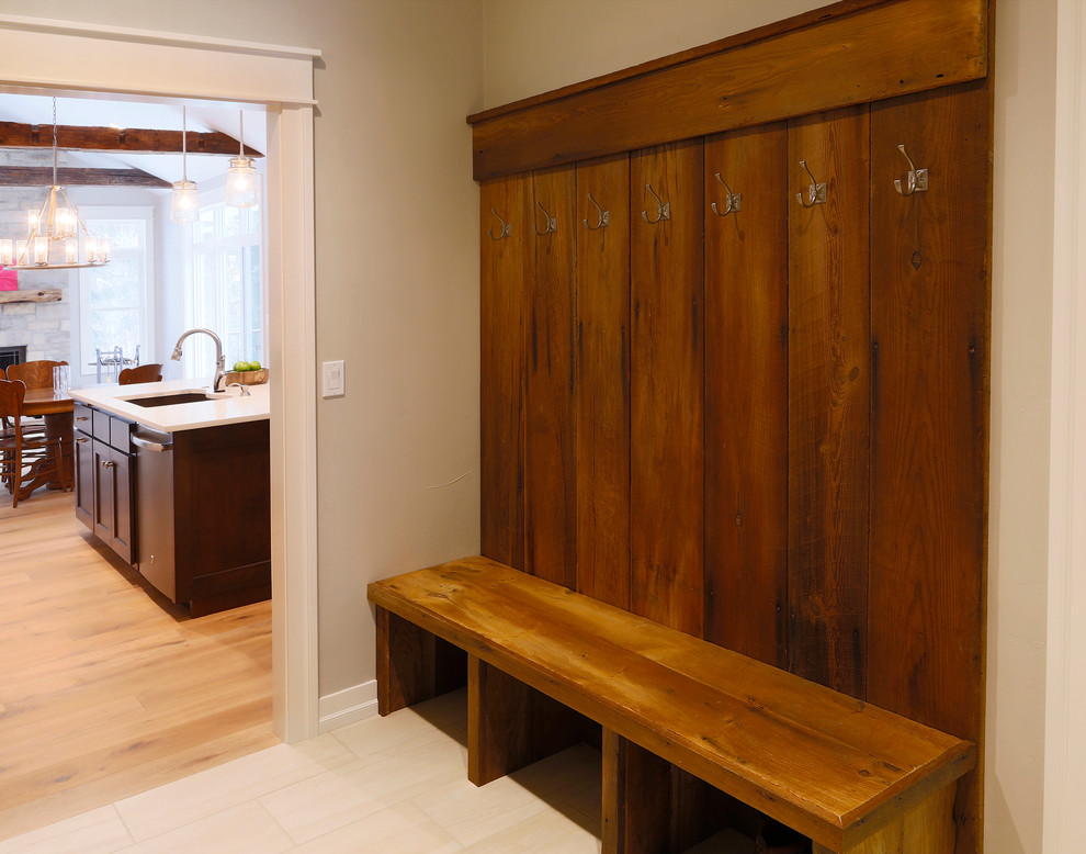 Inspiration for a mid-sized rustic mudroom remodel with beige walls
