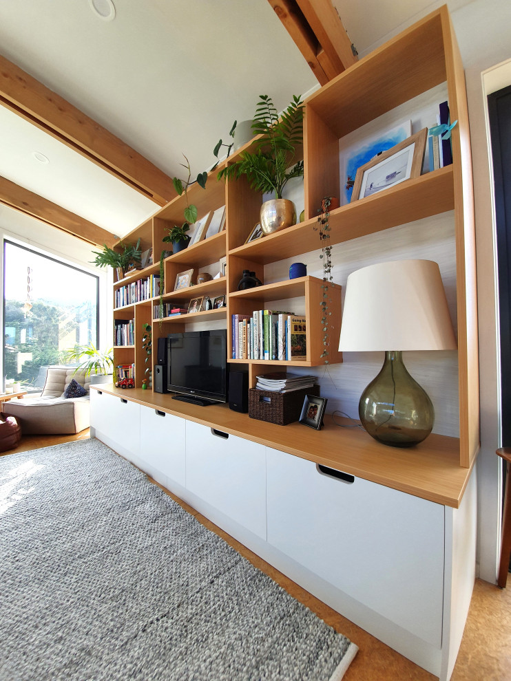 This is an example of a Mid-sized Scandinavian Open Concept living room in Dunedin With a Freestanding TV, White Walls, Cork Floors and Brown Floor.