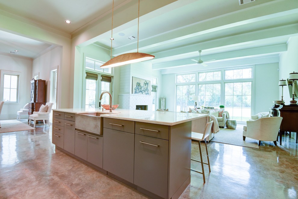 Open concept kitchen - mid-sized transitional l-shaped open concept kitchen idea in New Orleans with a farmhouse sink, flat-panel cabinets, gray cabinets, paneled appliances and an island