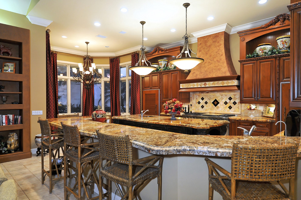 Design ideas for a mediterranean kitchen in Tampa with granite benchtops, raised-panel cabinets, dark wood cabinets and multi-coloured splashback.