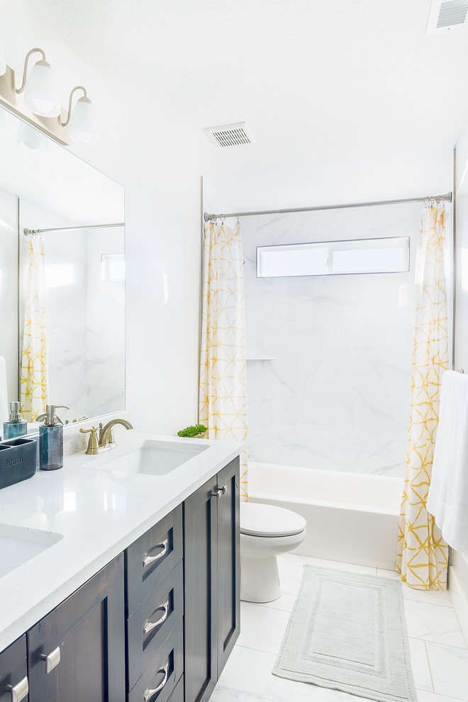 Mid-sized traditional 3/4 bathroom in Salt Lake City with shaker cabinets, dark wood cabinets, an alcove tub, a shower/bathtub combo, white tile, white walls, marble floors, an undermount sink, white floor, a shower curtain and white benchtops.
