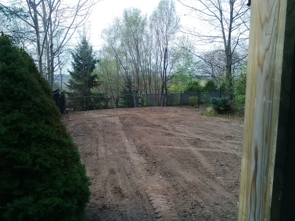 This is an example of a mid-sized full sun backyard landscaping.