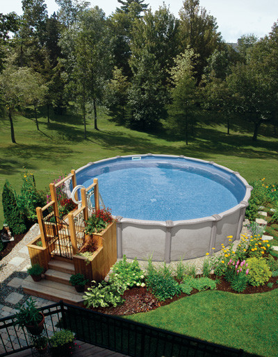 Photo of a large transitional backyard custom-shaped aboveground pool in Other.