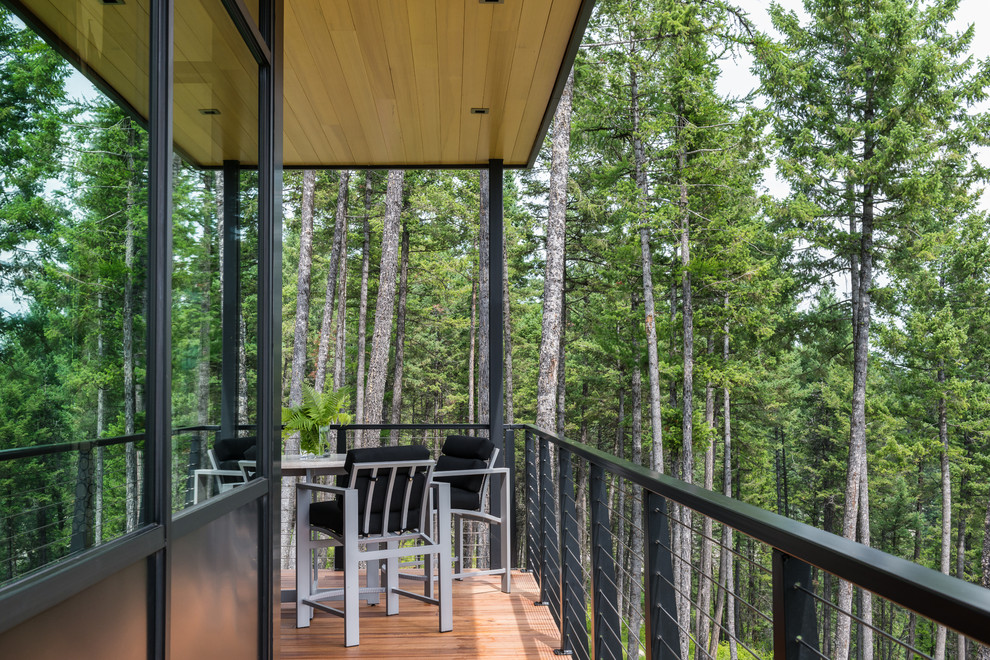 Inspiration for a mid-sized contemporary backyard deck in Other with a roof extension.