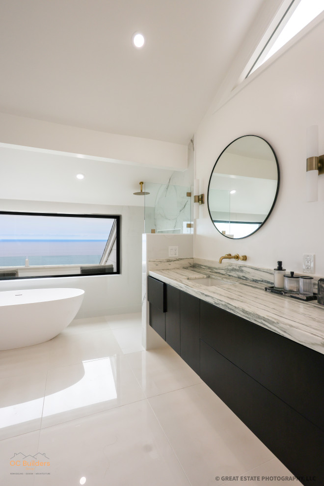 Example of a large minimalist master multicolored tile porcelain tile, white floor, double-sink and vaulted ceiling bathroom design in Orange County with flat-panel cabinets, black cabinets, a one-piece toilet, white walls, a drop-in sink, marble countertops, white countertops, a niche and a floating vanity