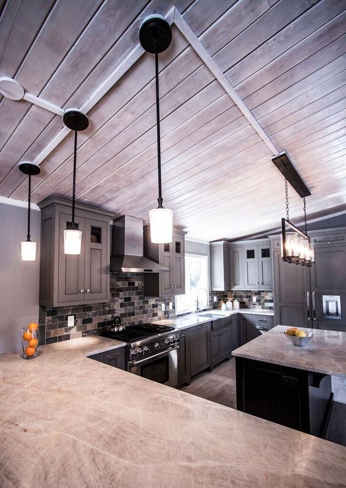 Eat-in kitchen - mid-sized transitional u-shaped light wood floor eat-in kitchen idea in Chicago with a farmhouse sink, flat-panel cabinets, green cabinets, quartzite countertops, multicolored backsplash, stone tile backsplash, paneled appliances and an island