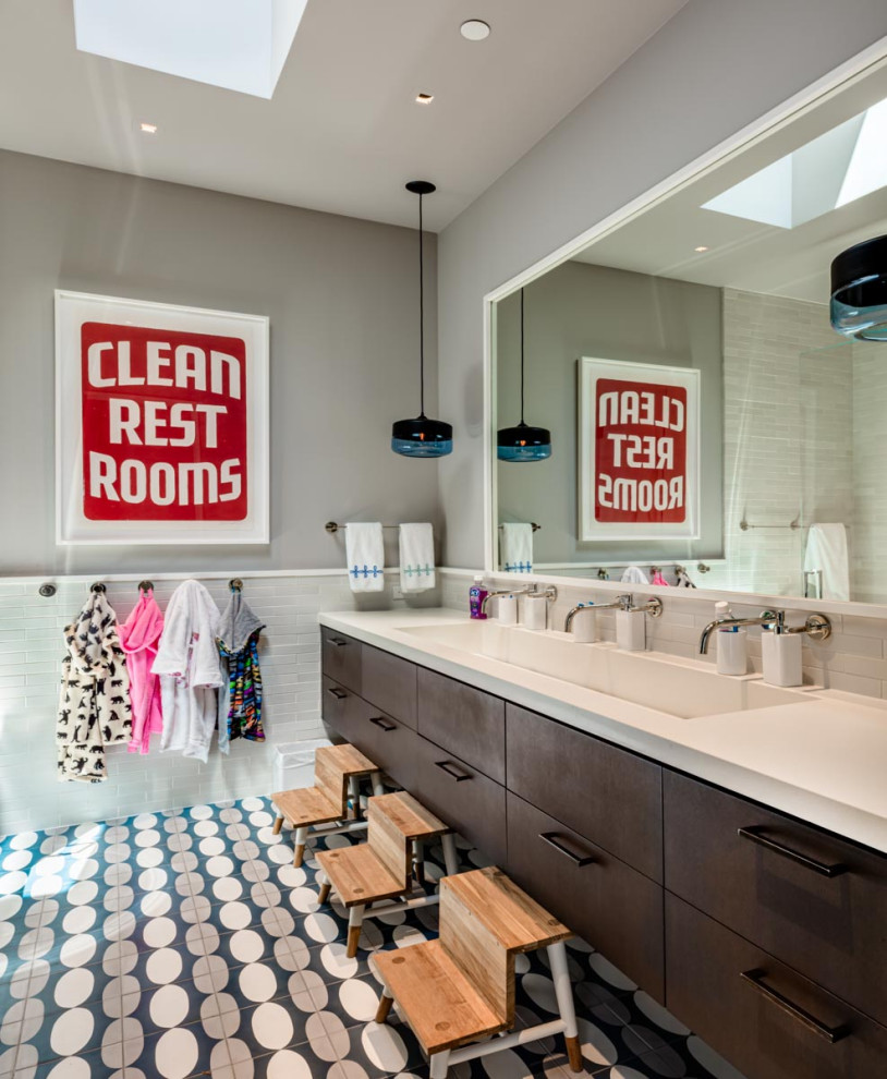 Design ideas for a transitional kids bathroom in San Francisco with flat-panel cabinets, brown cabinets, white tile, an integrated sink, engineered quartz benchtops, multi-coloured floor, white benchtops, a double vanity and a floating vanity.