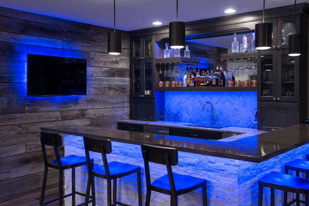 Photo of a large arts and crafts home bar in Indianapolis with laminate floors.