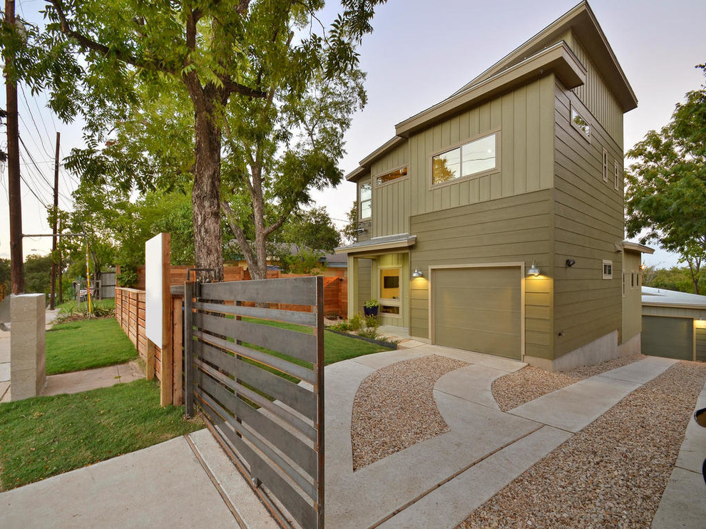 Design ideas for a contemporary two-storey green exterior in Austin.