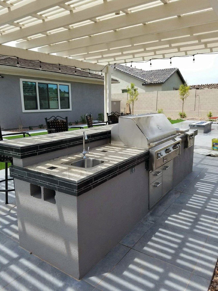 Design ideas for a mid-sized traditional backyard patio in San Diego with an outdoor kitchen, concrete pavers and a pergola.
