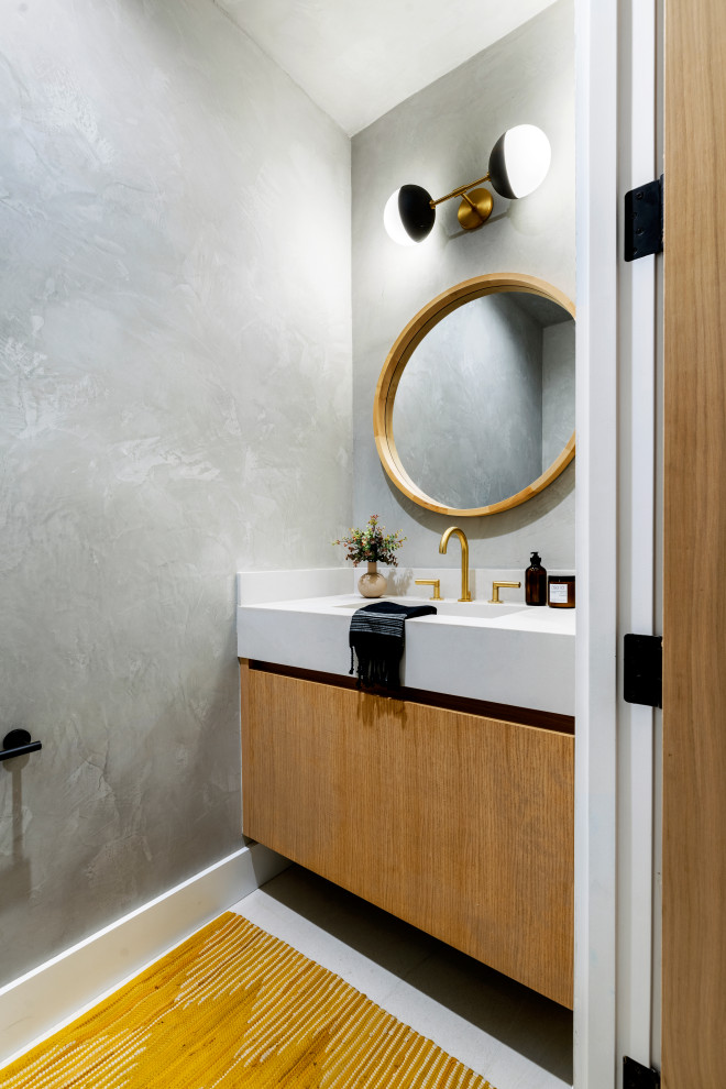 This is an example of a small contemporary cloakroom in Los Angeles with flat-panel cabinets, light wood cabinets, a wall mounted toilet, grey tiles, grey walls, ceramic flooring, quartz worktops, white floors, white worktops and a floating vanity unit.