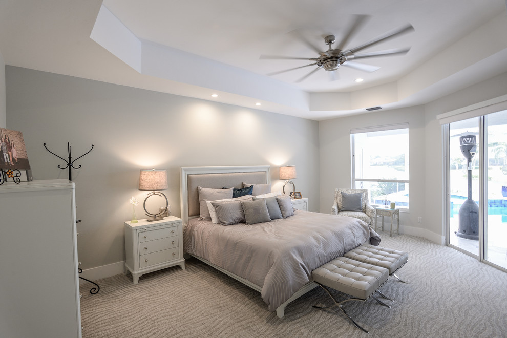 Mid-sized contemporary master bedroom in Other with grey walls, carpet, no fireplace and beige floor.