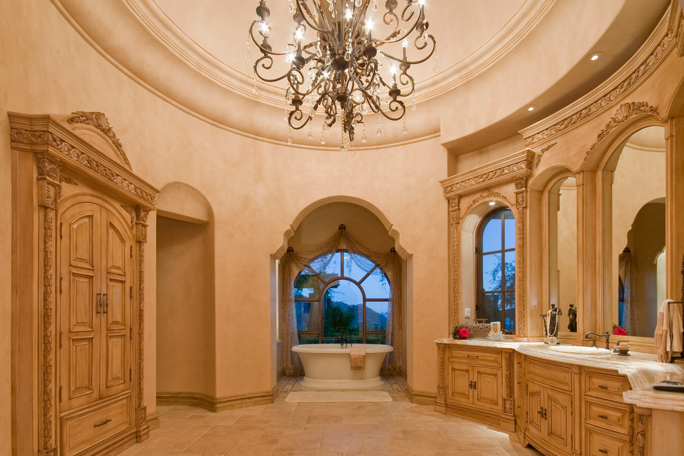 Photo of an expansive mediterranean master bathroom in Phoenix with recessed-panel cabinets, brown cabinets, a freestanding tub, an alcove shower, a one-piece toilet, multi-coloured tile, ceramic tile, multi-coloured walls, a vessel sink, quartzite benchtops, multi-coloured floor, an open shower, multi-coloured benchtops, marble floors, a single vanity, a built-in vanity and vaulted.