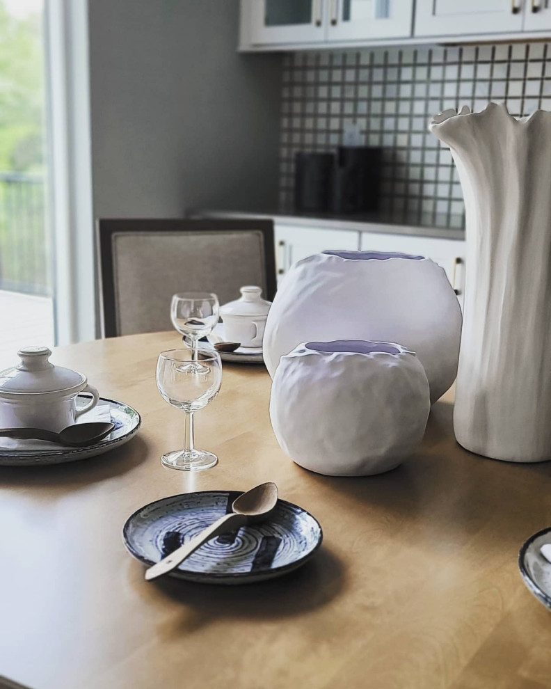 Transitional medium tone wood floor dining room photo in Cedar Rapids with gray walls