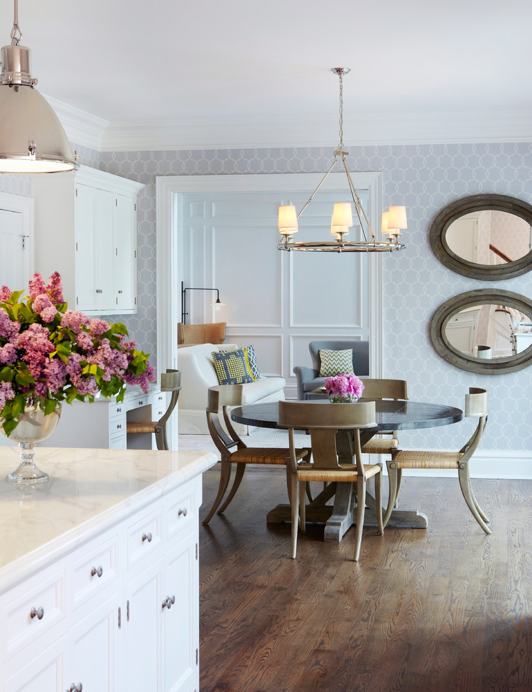 This is an example of a transitional eat-in kitchen in New York with white cabinets.