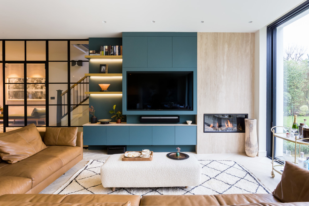 Inspiration for a scandinavian open concept family room in London with blue walls, a ribbon fireplace and a built-in media wall.