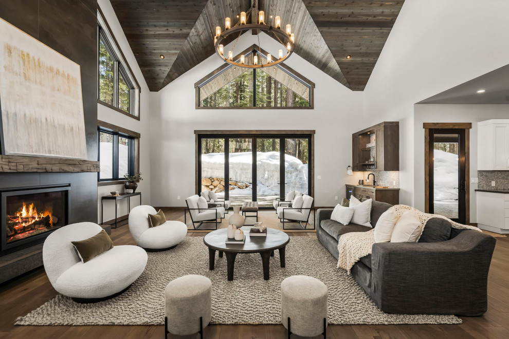 Photo of a rustic open plan living room in Other with white walls, dark hardwood flooring, a standard fireplace, a metal fireplace surround, brown floors, a vaulted ceiling and a wood ceiling.