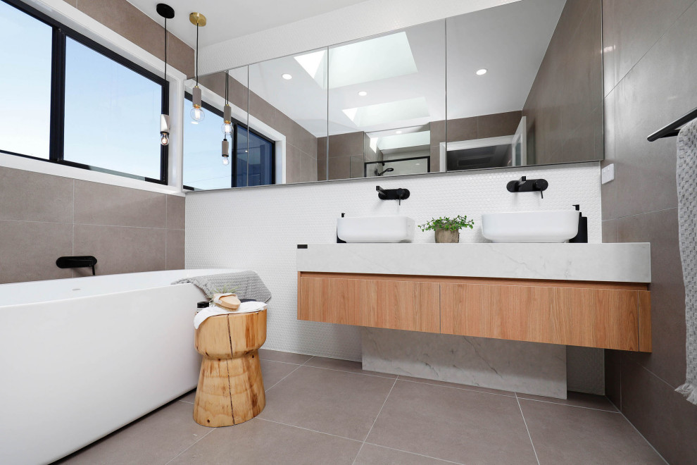 This is an example of a contemporary master bathroom in Sydney with gray tile, porcelain floors, engineered quartz benchtops, grey floor, a double vanity and a floating vanity.